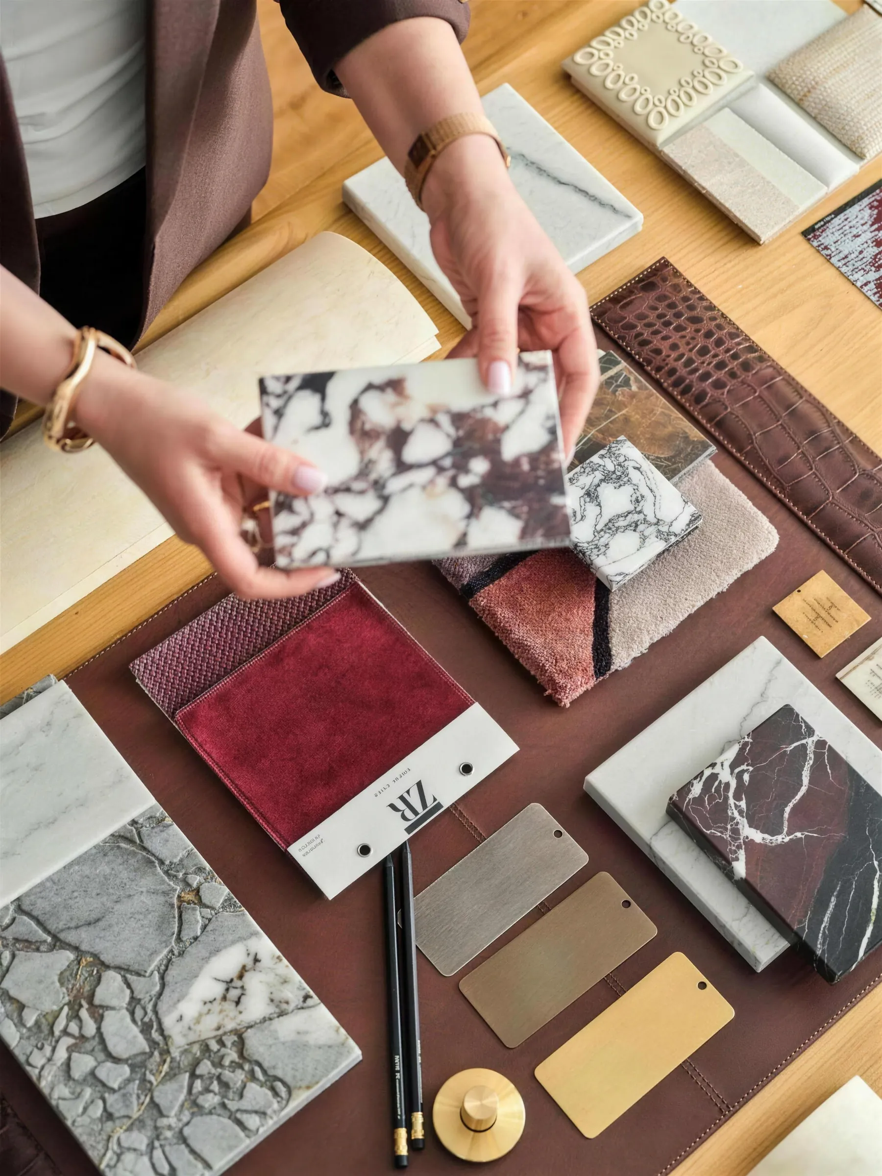 Material samples in the Faura showroom — marble, timber, brass and textiles